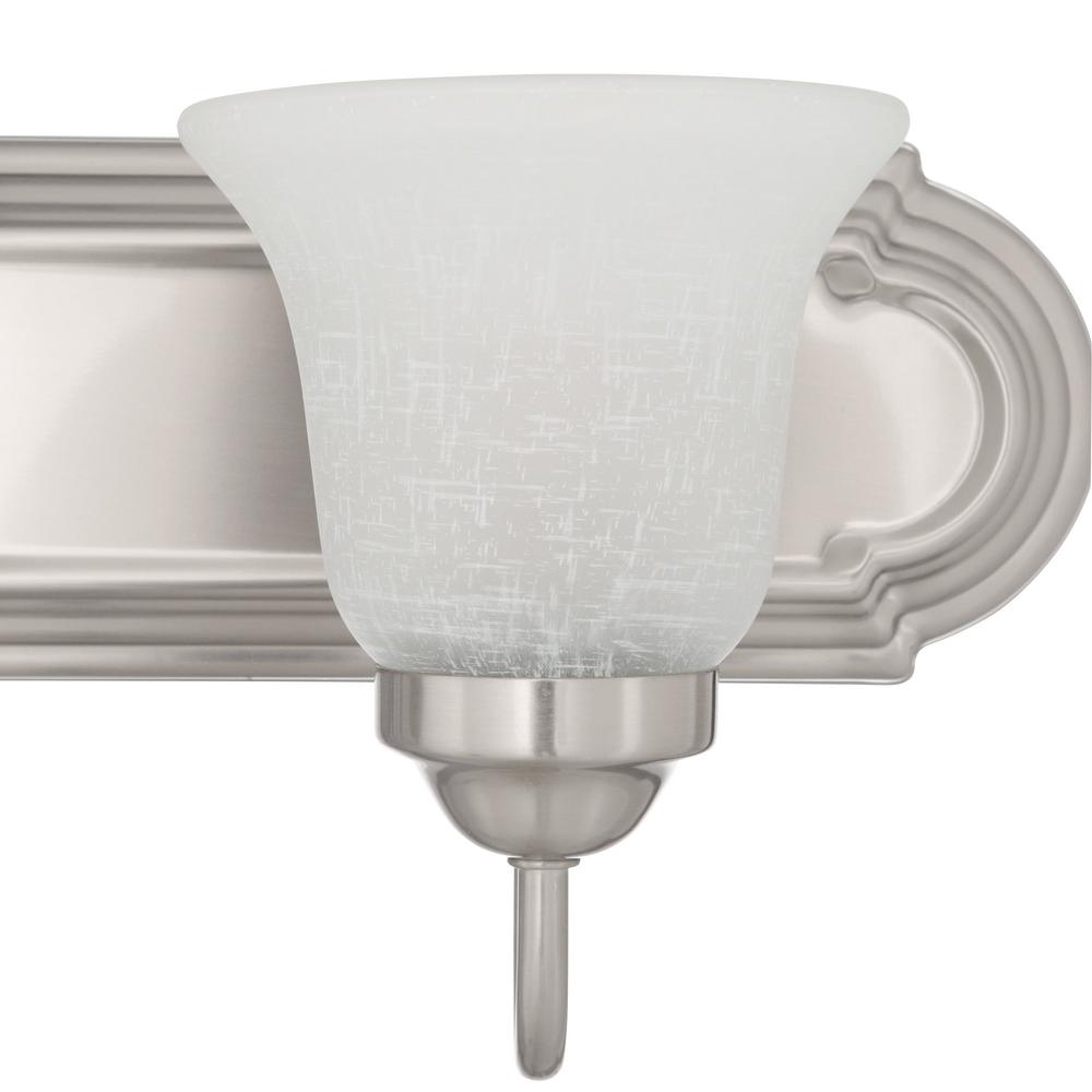 Vanity light featuring glass bell shades