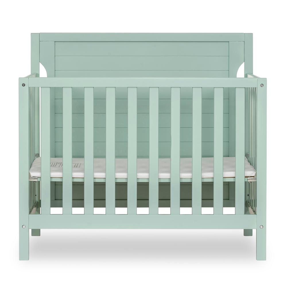 green mini crib