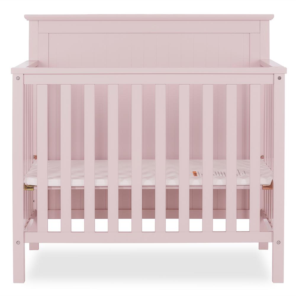 pink crib with changing table